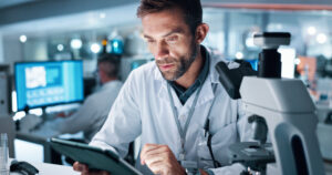 research scientist man lab tablet internet with medical analysis healthcare test results person employee researcher with tech cure digital app with vaccine manufacturing